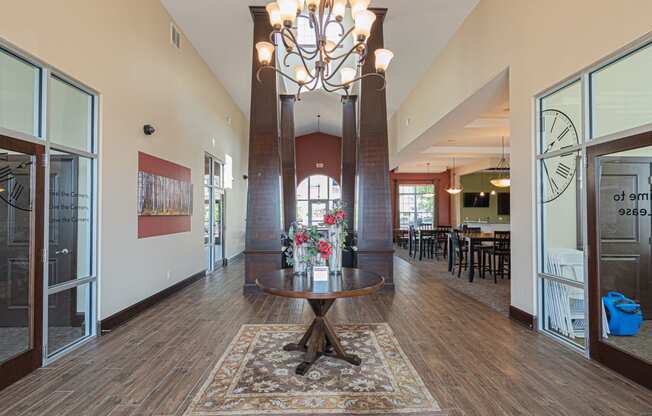 a large lobby with a table and a chandelier