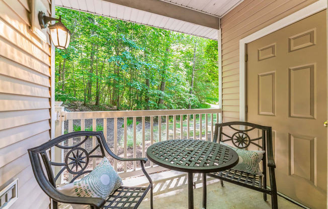 a patio with a table and chairs on a porch