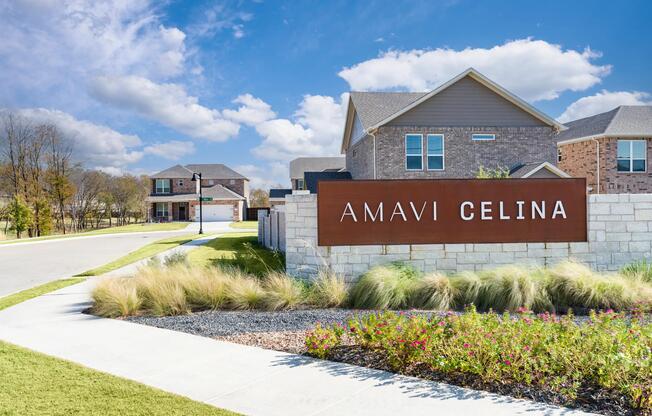A distinctive community entry framed by landscaped greens and sidewalks, offering a warm first impression of this single-family neighborhood in Celina.