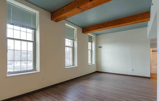 A room with wooden floors and a window.