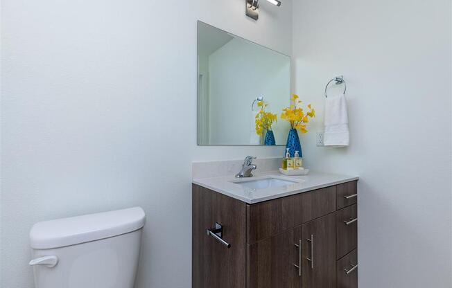 a bathroom with a toilet sink and mirror at Jefferson Yards, Tacoma, 98402