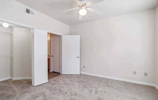 an empty living room with white walls and a ceiling fan at St. Augustine Estate, Texas