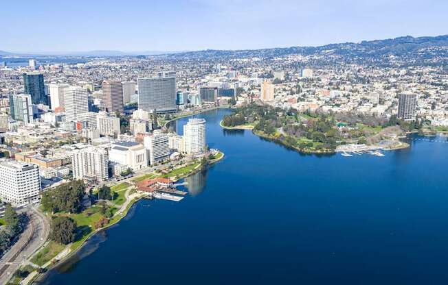 A cityscape with a large body of water in the foreground and a smaller island with buildings.