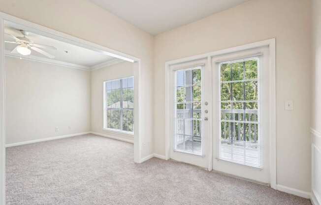 Living and dining room with carpeted floor, and windows