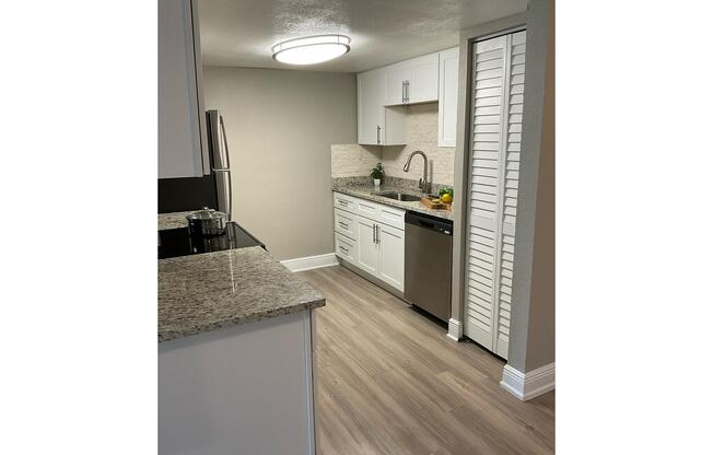 a kitchen with a stove and a refrigerator