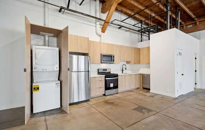 A kitchen area with a refrigerator, stove, and microwave.