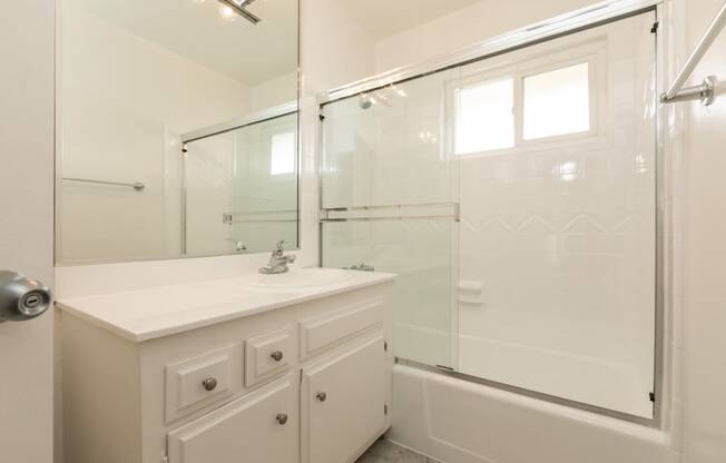 Bathroom with White Cabinets and Bathtub/Shower