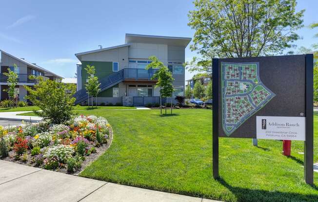 Addison Ranch Apartments Company Sign with  Wood Chip Floor, Flower Beds, Fire Hydrant, and Road