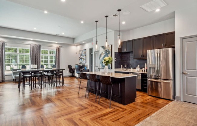 a kitchen with stainless steel appliances and a wooden floor