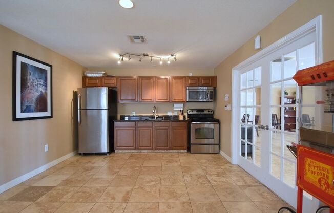 a kitchen with wooden cabinets and stainless steel appliances