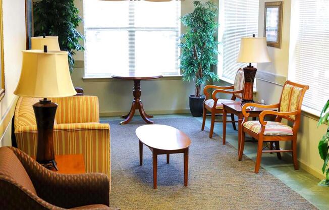 A living room with a brown chair and a yellow lamp.