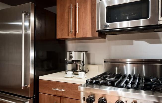 a kitchen with a stove top oven next to a refrigerator  at The Sheffield Englewood, Englewood, NJ