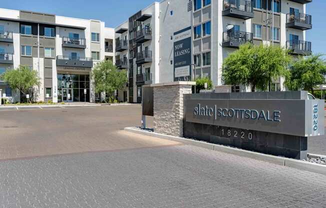 a view of the main entrance to slate scottsdale apartments in the background