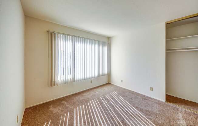 a bedroom with a large window and a closet at Terrace View Apartments, California, 94015