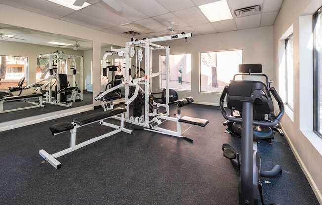 A gym with a variety of equipment including a leg press machine.