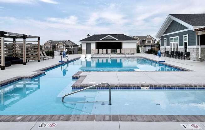 A swimming pool with a slide and a building in the background.