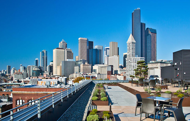 a rooftop terrace with a view of the city