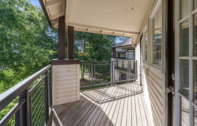 the view from the deck of a home with a deck railing and a porch