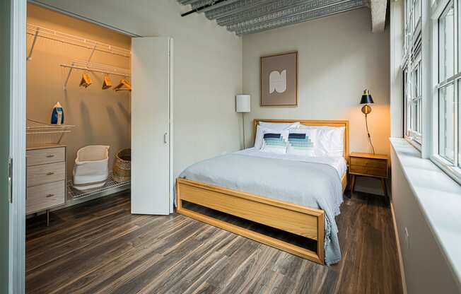 a bedroom with a bed and a bathroom with a shower