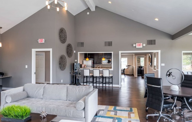 a living room with gray walls and a vaulted ceiling at Misty Ridge Apartments, Woodbridge