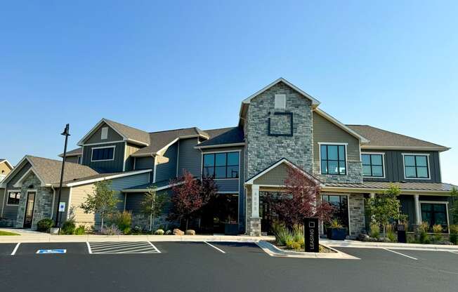 a large house with a parking lot in front of it