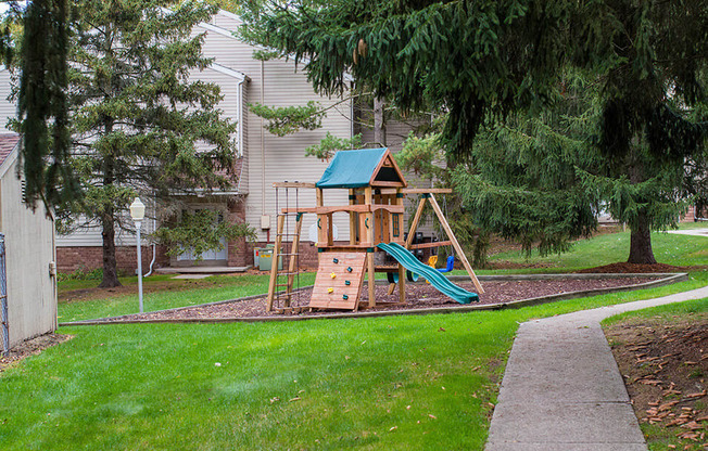 a swing set in the backyard of a house