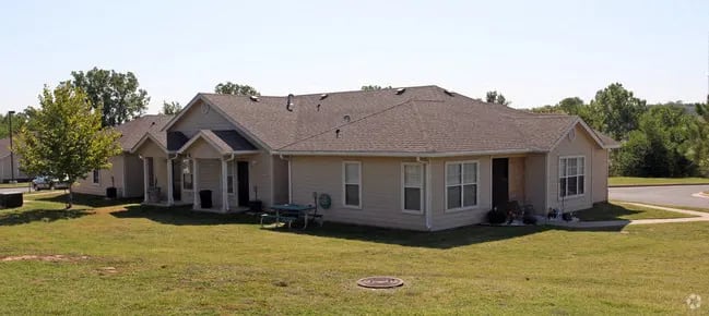 a row of houses on a grassy field at EDGEWOOD AT GABLES Apartments, TULSA, Oklahoma