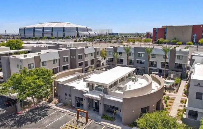 an aerial view of an apartment complex with a soccer stadium in the background