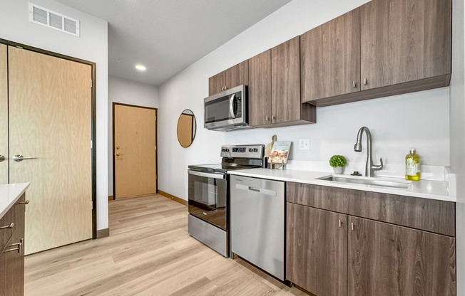 a kitchen with stainless steel appliances and wooden cabinets