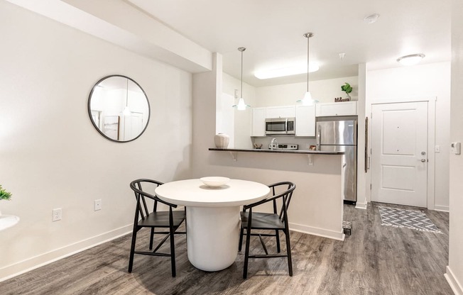 a kitchen and dining room with a white table and chairs