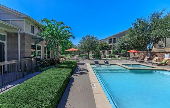 a house with a pool outside of a building