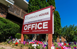 Office sign and landscaping at Carriage House Apartments in Flint, Michigan