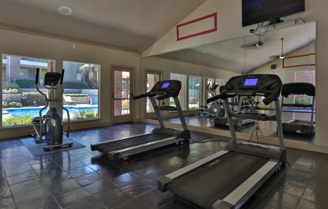 treadmill in front of mirror of fitness room