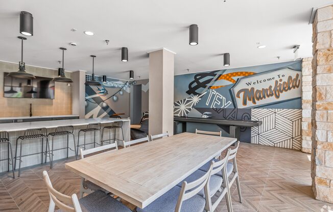 A room with a wooden table and chairs and a mural on the wall. at Aurora Watson Branch, Texas, 76063