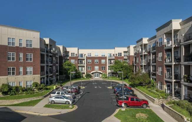 A parking lot in front of apartment buildings.