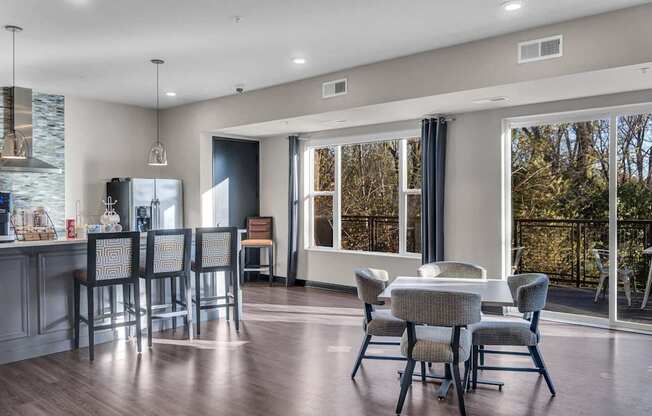 A modern kitchen with a dining table and chairs.