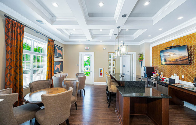 a living room with tables and chairs and a bar
