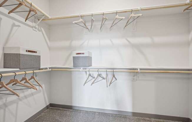 a walk in closet with hangers and a dryer at The Quarry Luxury Apartment Homes, Fort Collins, Colorado