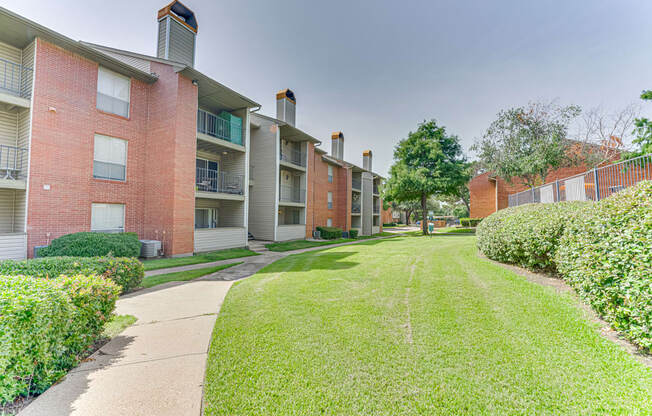 A grassy area in front of apartment buildings at Copper Hill Apartments, Texas