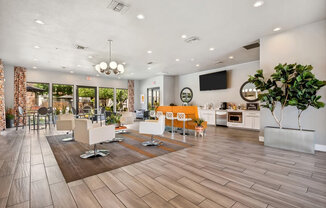 Community Clubhouse with Lounge Furniture and TV at Harmony at Surprise Apartments in Surprise, AZ.