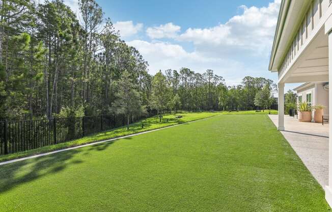 a yard with green grass next to a house at Drift, Daytona Beach, FL, 32117