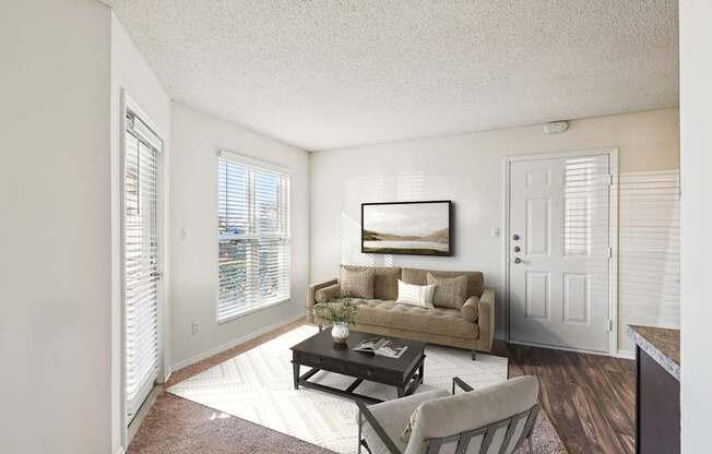 A living room with a couch, chair, and coffee table.