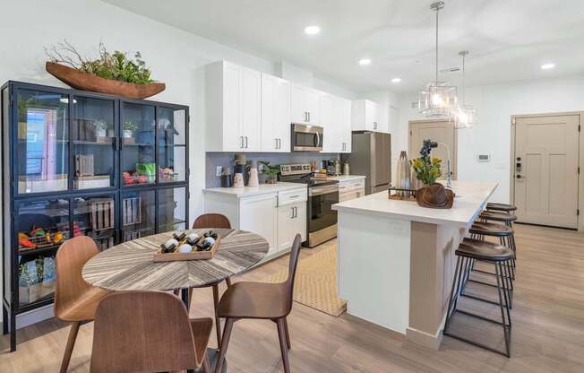 A modern kitchen with a dining table and chairs.