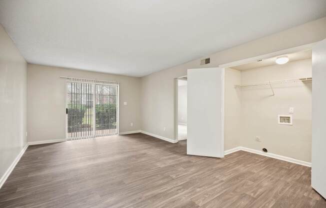 A room with wooden flooring and white walls.