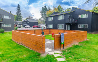 a wooden privacy fence with a fire hydrant in the background