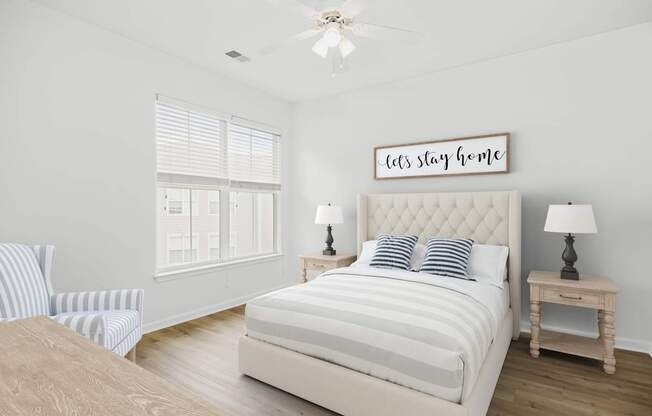 A bedroom with a large bed and a sign that says