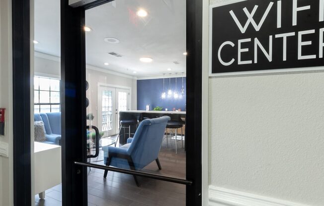 a view of a living room with a wii center sign in the window