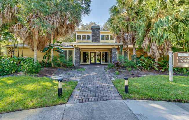 a house with palm trees in front of it