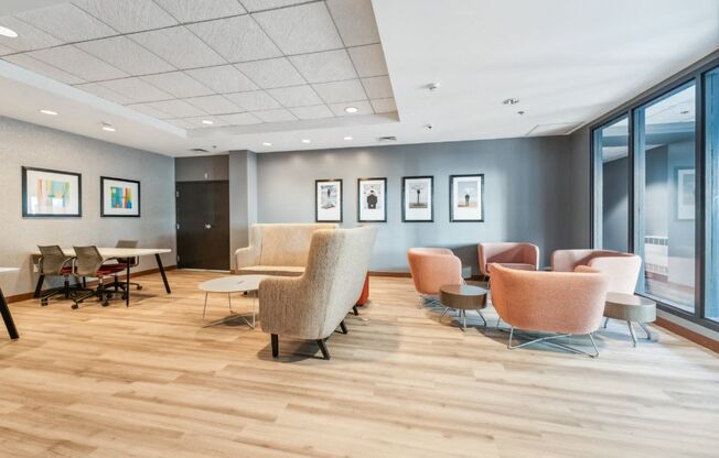 a waiting room with chairs and tables and windows