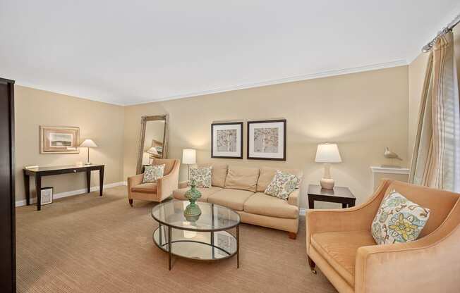 a living room with couches and chairs and a table